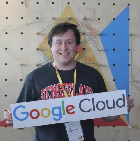 Ian holding a Google Cloud sign, wearing an Innovator name badge