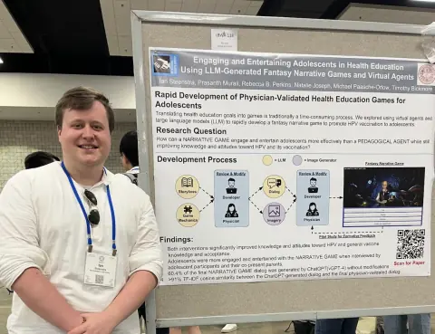 Ian beside a poster on LLM-generated fantasy narrative games for HPV education